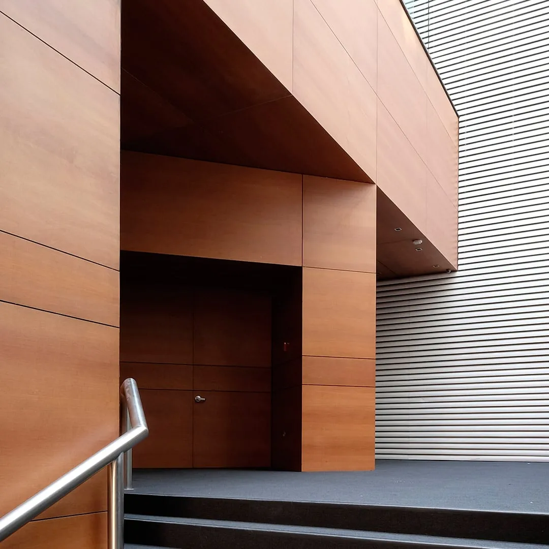 Centro Asturiano Polanco: acceso entre volúmenes revestidos de madera