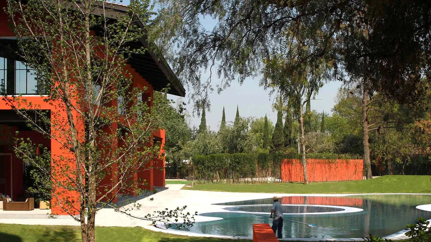 Hacienda San Miguel: estanque y jardín frente al edificio rojo