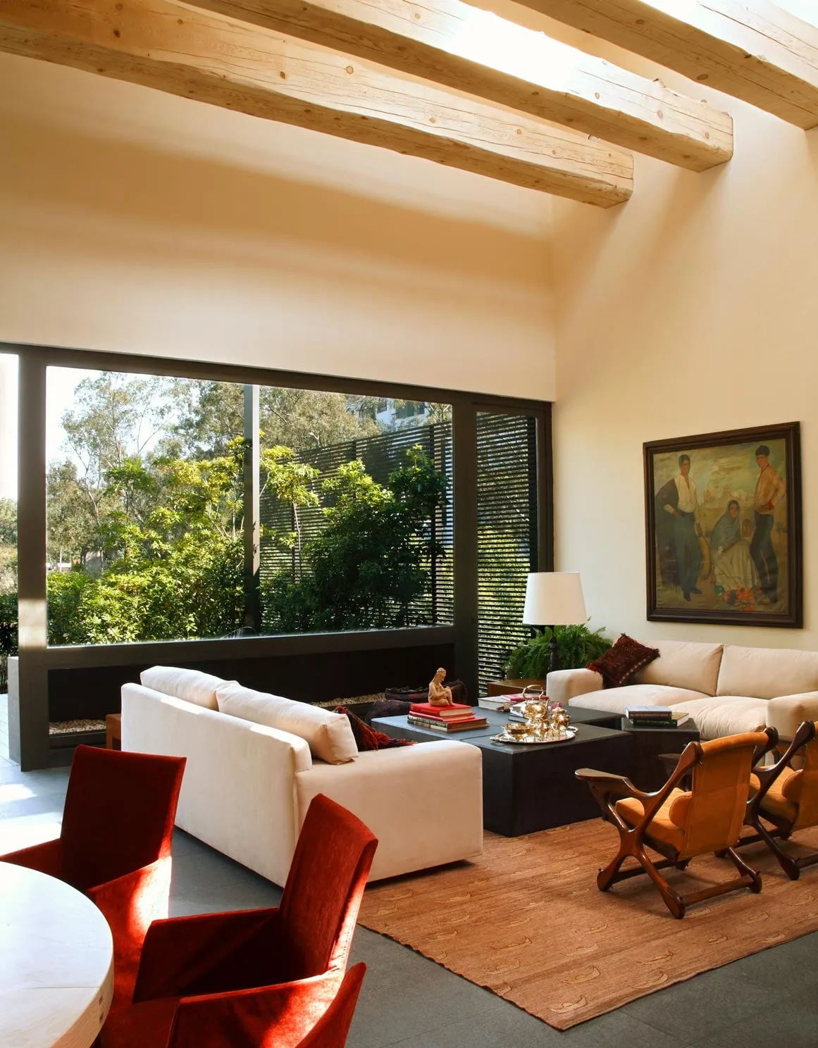 Casa LO: estancia con vigas de madera y ventanal al bosque